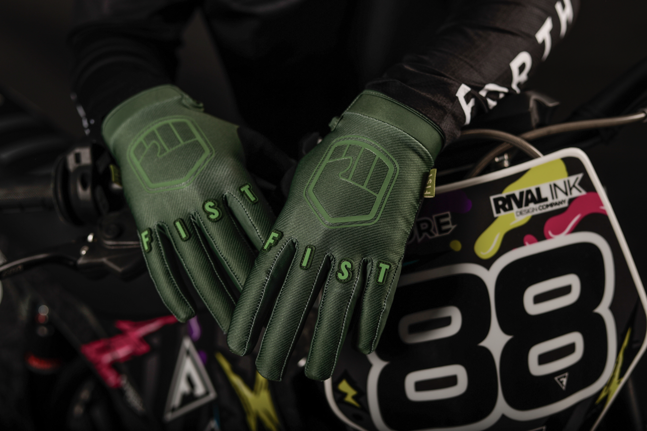 FIST HANDWEAR Strapped Earth Stocker gloves in olive green, medium size, featuring a rugged design with straps for grip and durability.