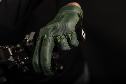 FIST HANDWEAR Strapped Earth Stocker gloves in olive green, medium size, with durable strap and reinforced palm for outdoor work.