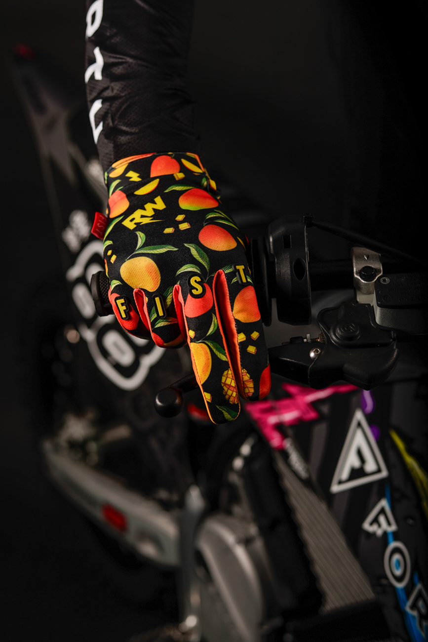 FIST Handwear Strapped R-Willy Mango Madness Gloves in red, XS size, with fingerless design and strap closure, laid flat.