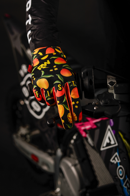 FIST Handwear Strapped R-Willy Mango Madness Gloves in red, XS size, with fingerless design and strap closure, laid flat.