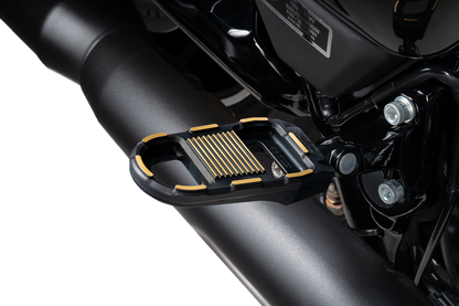 Black and gold DRAG SPECIALTIES adjustable motorcycle foot pegs with mounting hardware, designed for custom bike upgrades.