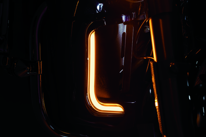 Kuryakyn Tracer LED fairing lower accents in chrome on a Harley Davidson touring motorcycle, showcasing sleek, illuminated design.