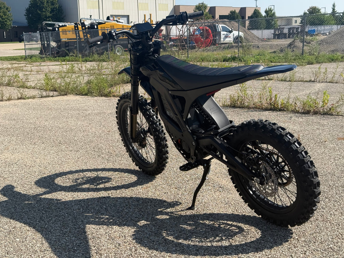 E Ride Pro SR electric dirt bike with 25KW motor, sleek black frame, off-road tires, and visible Samsung 72V battery system.
