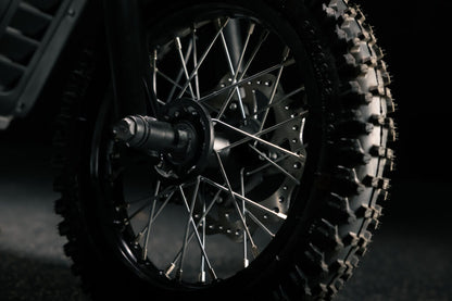 Greenger G2 electric dirt bike for kids, 50cc equivalent, with black and red frame and off-road tires.