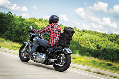 Kuryakyn Momentum Freeloader Duffle bag mounted on a powersports sissy bar, designed for quick and secure attachment for riders.