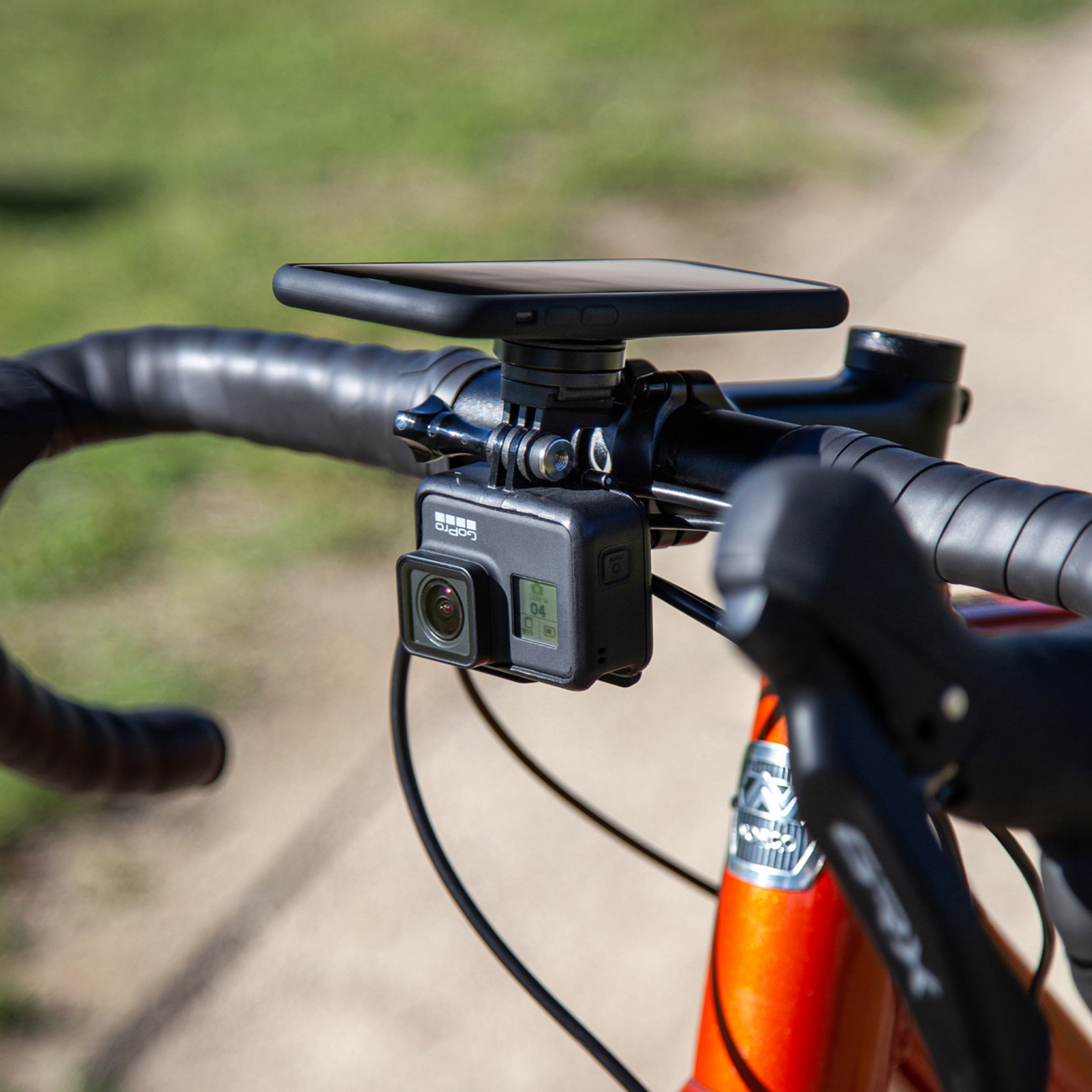 Bill's Exhausts SP CONNECT Adapter for Phone Camera and Light attachment, shown mounted on a smartphone.