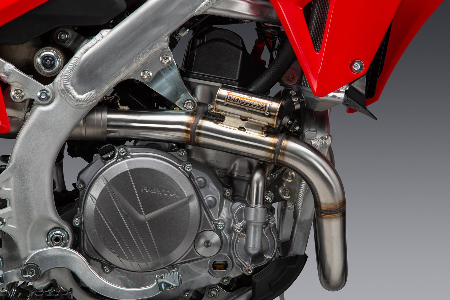 YOSHIMURA RS-12 exhaust system for Honda CRF450 with matte carbon fiber end cap, showcasing the sleek motorcycle exhaust design.