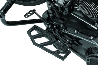 Kuryakyn Riot Floorboards for Harley Davidson in satin black with textured surface and mounting hardware.