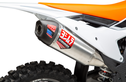 YOSHIMURA RS-12 slip-on exhaust installed on KTM and Husqvarna motorcycles, showcasing the sleek silver and black design.