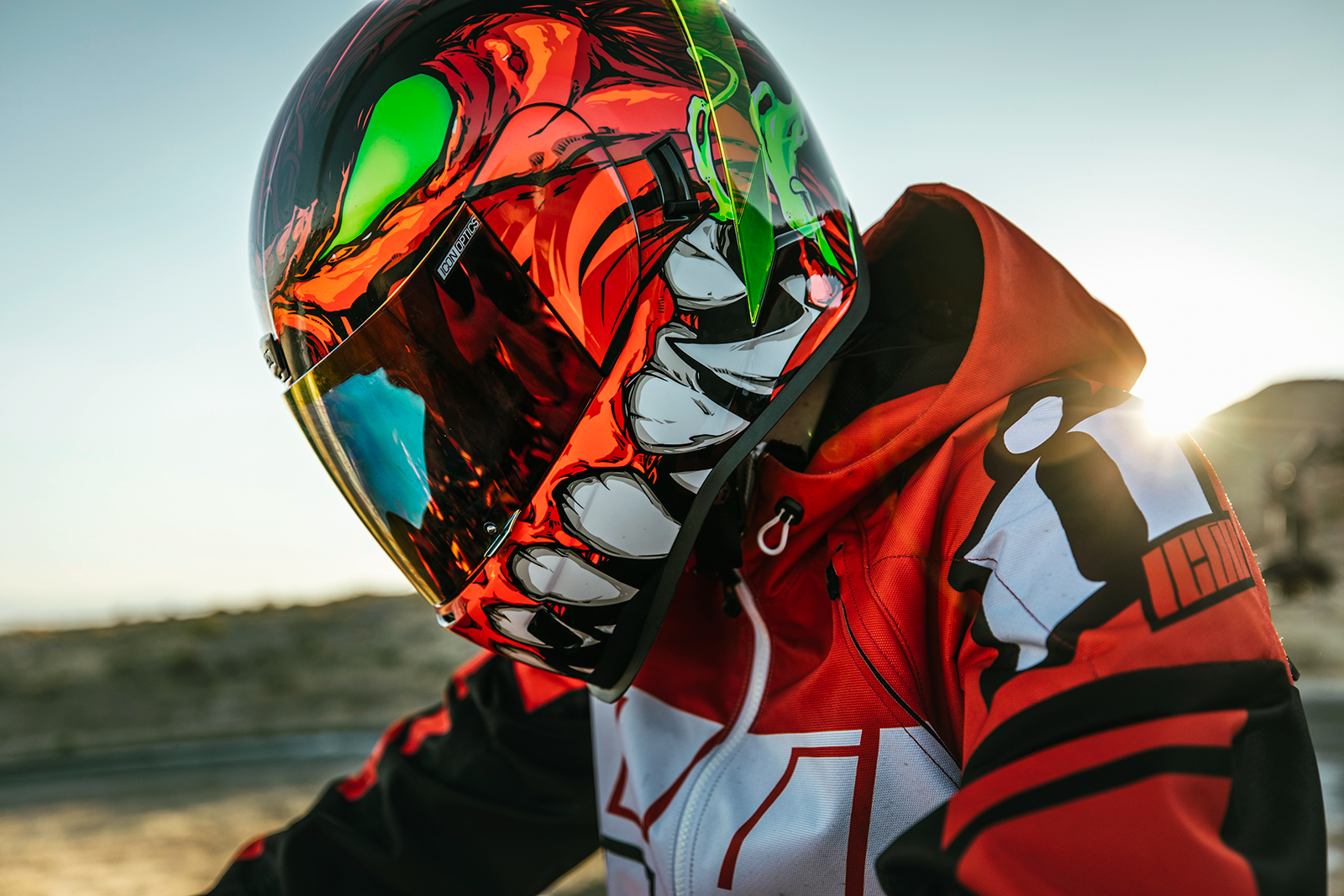Red ICON Airform™ helmet for men, medium size, featuring a sleek design and adjustable straps.