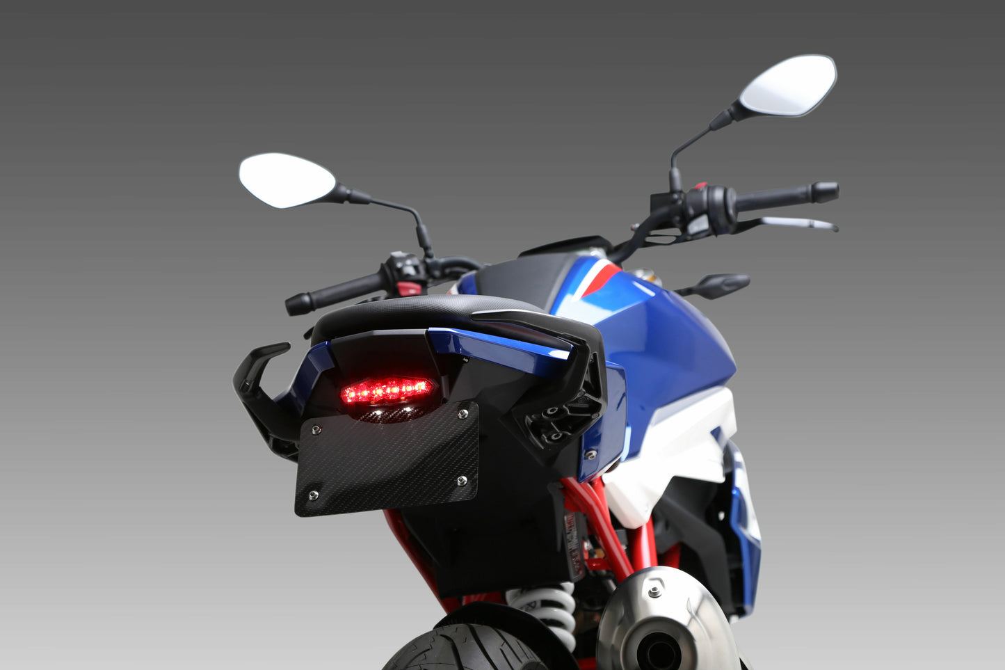 YOSHIMURA V2 Fender Eliminator Kit for BMW motorcycle, showing sleek black design and mounting hardware.