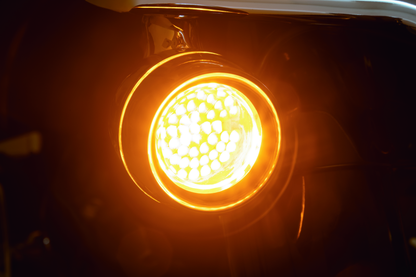 Kuryakyn Luminez LED front turn signal insert in amber for Harley-Davidson motorcycles, with clear lens and compact design.