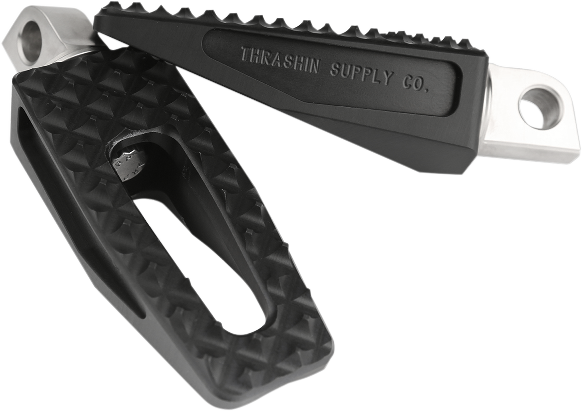 Black THRASHIN SUPPLY CO. P-54 slim foot pegs for motorcycle, shown in close-up view with detailed metal finish.