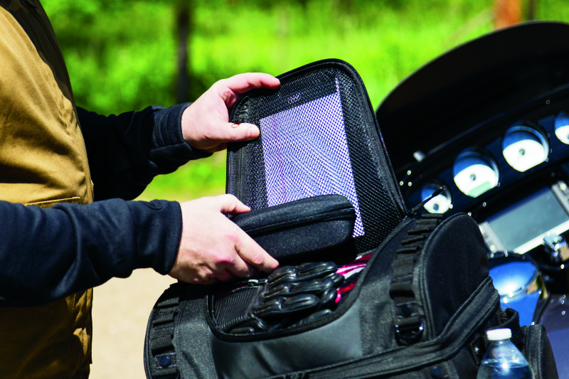 Kuryakyn Momentum Vagabond Bag mounted on a motorcycle seat, showcasing versatile luggage rack and storage options for riders.