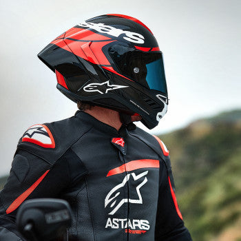 Alpinestars Supertech R10 motorcycle helmet in carbon, red, and white with a sleek aerodynamic design, small size.
