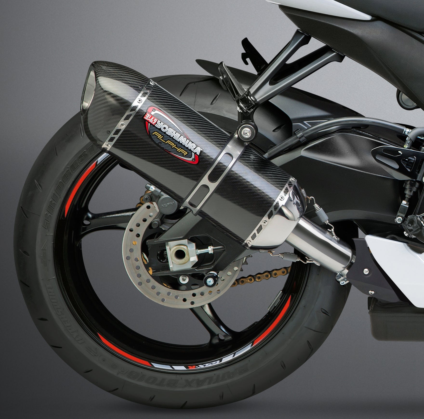 YOSHIMURA Signature Alpha slip-on exhaust with matte carbon fiber end cap, showcasing sleek motorcycle exhaust design.