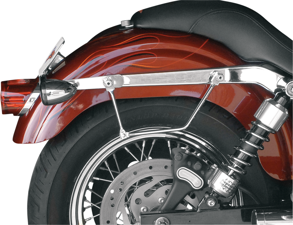 SADDLEMEN Drifter Rigid Slant Saddlebag on motorcycle seat, black leather with metal hardware, designed for rugged touring rides.