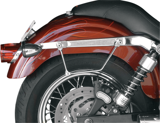 SADDLEMEN Drifter Rigid Slant Saddlebag on motorcycle seat, black leather with metal hardware, designed for rugged touring rides.