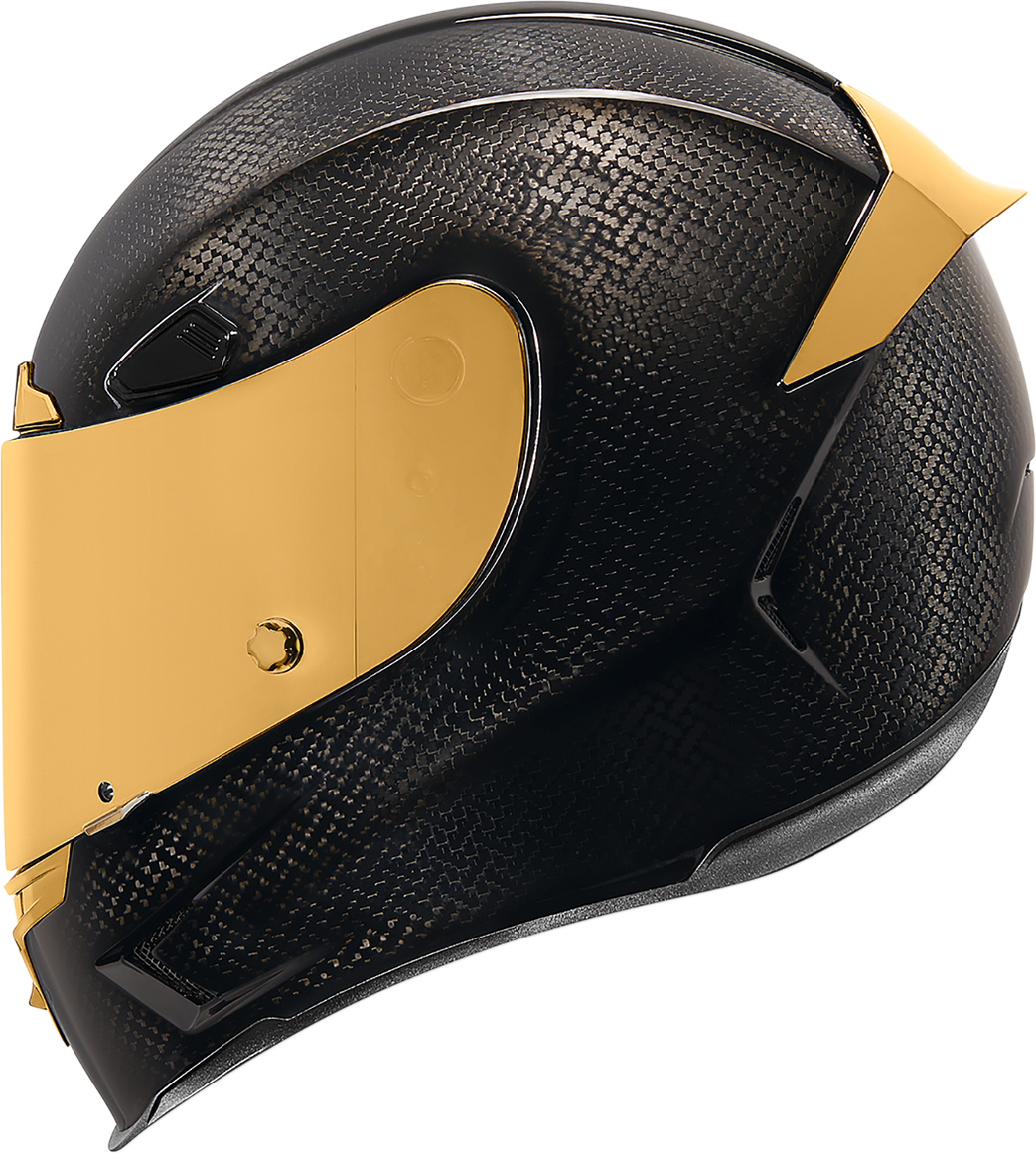 Black and gold ICON Airframe Pro™ helmet with carbon shell, small size, featuring sleek aerodynamic design and detailed graphics.