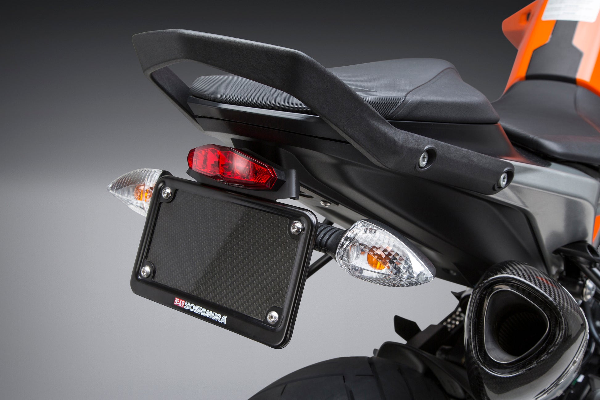 YOSHIMURA Fender Eliminator Kit for KTM motorcycle, showing sleek black tail tidy with mounting hardware and license plate holder.