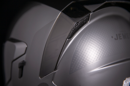 Silver ICON Airflite™ helmet with MIPS® technology in large size, featuring a jewel design and aerodynamic shape.