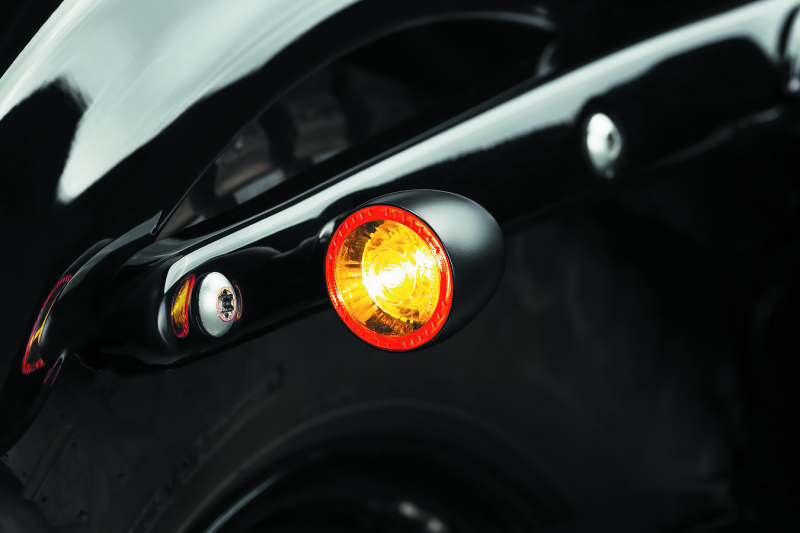 Kuryakyn Bullet 1000 LED turn signal light with white/amber clear lens and satin black housing for powersports vehicles.