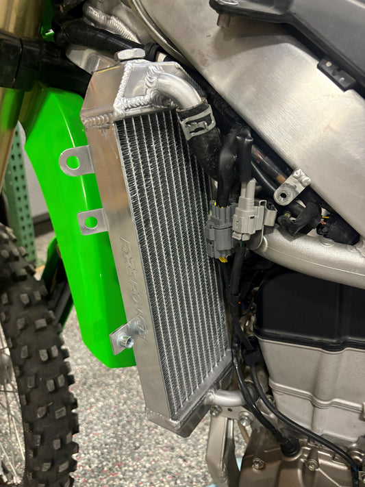 FIRE POWER TRS-R-140L radiator for Kawasaki motorcycle, high-performance aluminum cooling solution with visible cooling fins and mounting points.
