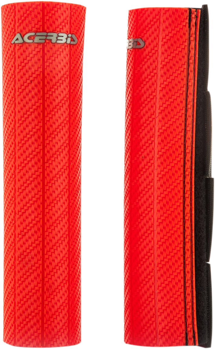 A close-up of a red Acerbis upper fork guard for motorcycle suspension, branded with the Acerbis logo and mounted on a bike.