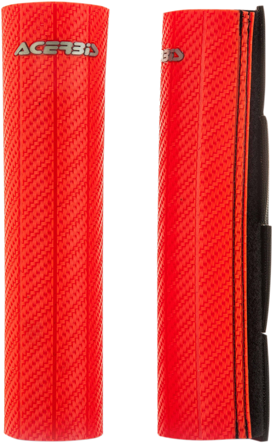 A close-up of a red Acerbis upper fork guard for motorcycle suspension, branded with the Acerbis logo and mounted on a bike.
