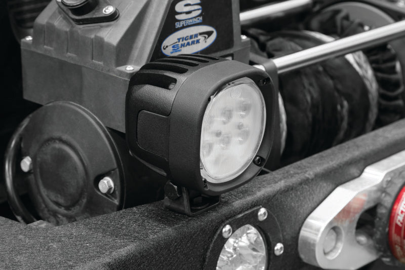 Kuryakyn Lodestar 1850L spot beam high-output driving lights for powersports vehicles, showing the bright LED light and mounting hardware.
