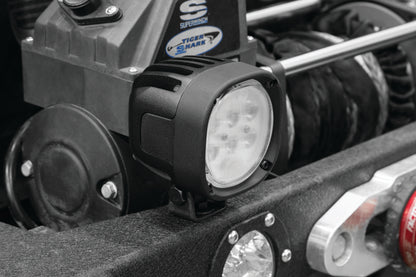 Kuryakyn Lodestar 1850L spot beam high-output driving lights for powersports vehicles, showing the bright LED light and mounting hardware.