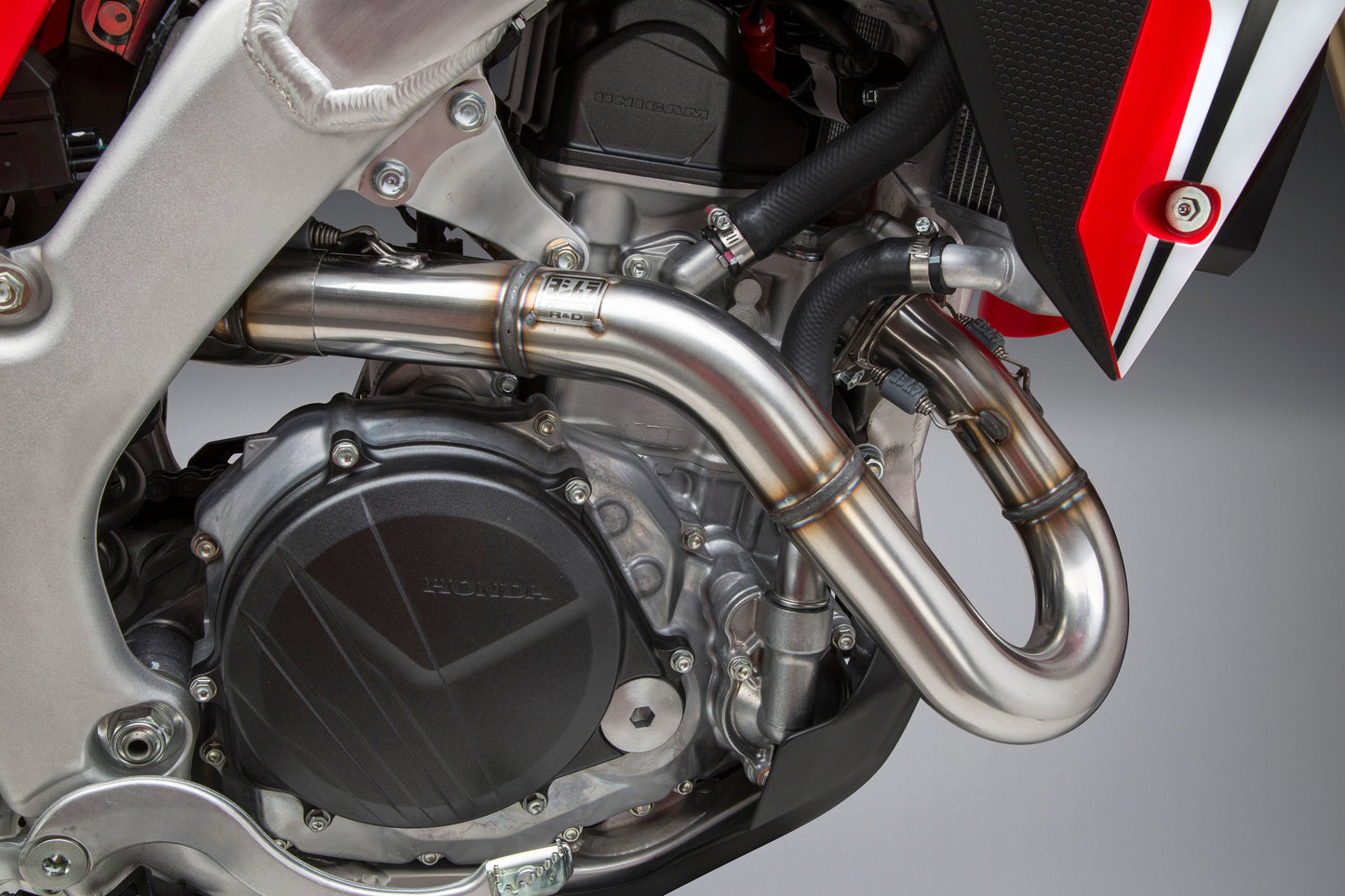 YOSHIMURA RS-9 dual slip-on stainless steel and carbon fiber motorcycle exhaust header, canister, and end cap system.