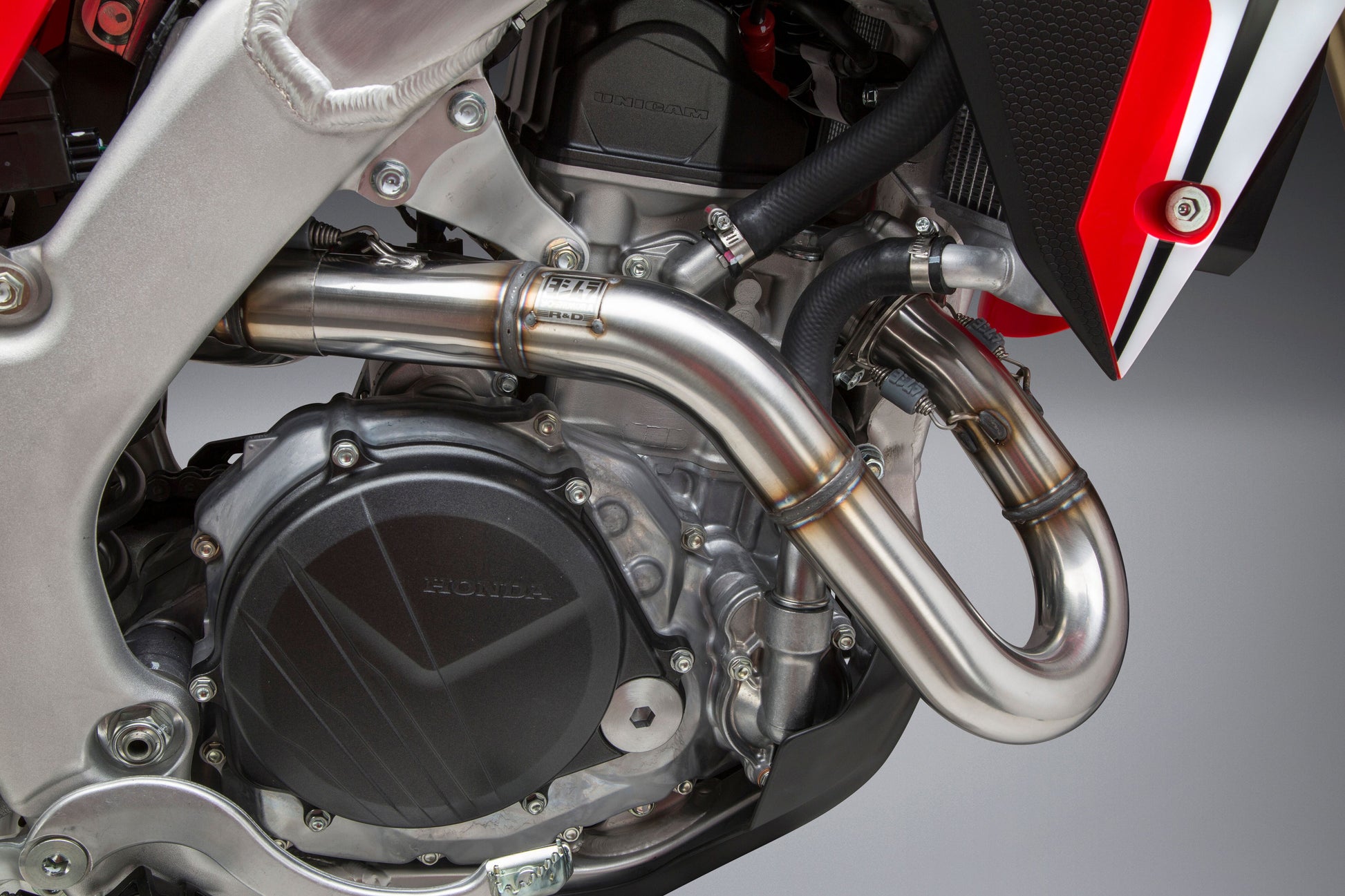 YOSHIMURA RS-9 dual slip-on stainless steel and carbon fiber motorcycle exhaust header, canister, and end cap system.