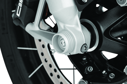 Kuryakyn Lodestar front axle sliders on BMW R1200GS and RT motorcycle, providing protection for the front wheel and axle.