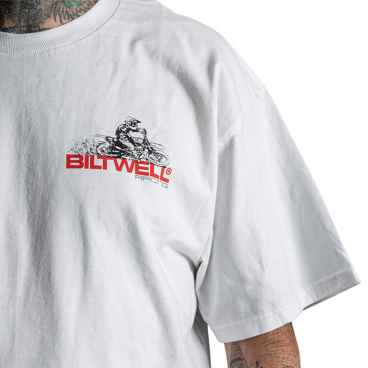 White BILTWELL Spare Parts T-Shirt in medium size, featuring the Bill's Exhausts logo on the front, made of soft cotton fabric.