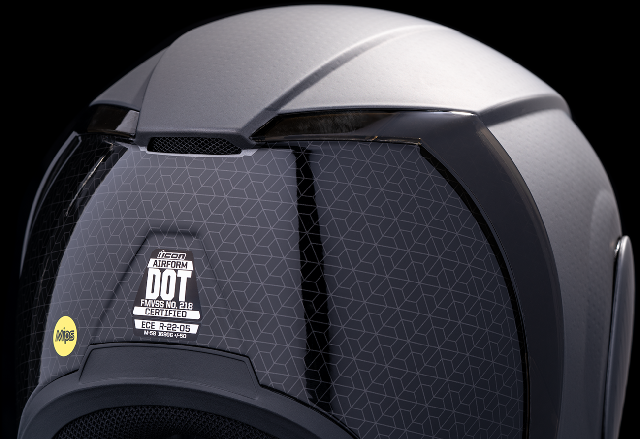 Silver ICON Airform MIPS helmet in XS size with Counterstrike design, featuring a sleek, aerodynamic shape and secure strap.
