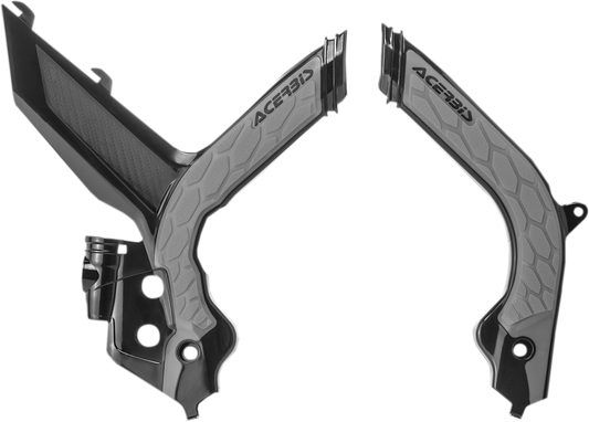 A close-up of black and silver Acerbis X-Grip frame guards on a motorcycle, showcasing their durable body protection design.