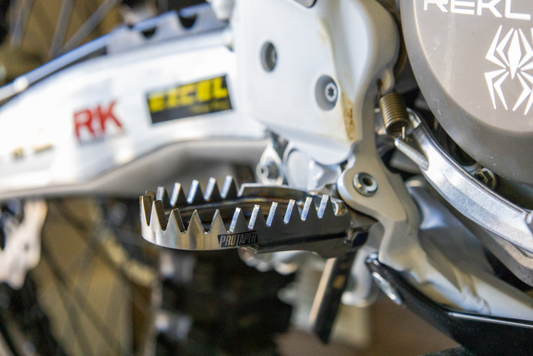 ProTaper Kawasaki titanium footpegs for powersports, lightweight and durable motorcycle footrests with textured grip surface.