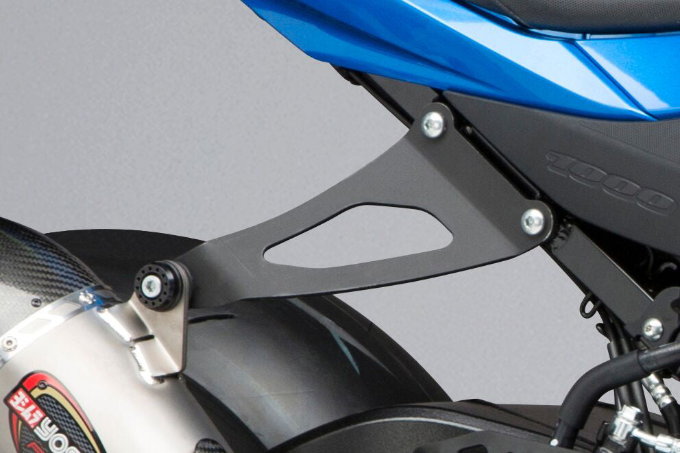 YOSHIMURA aluminum muffler bracket kit for lightweight exhaust mounting, shown installed on motorcycle exhaust system.