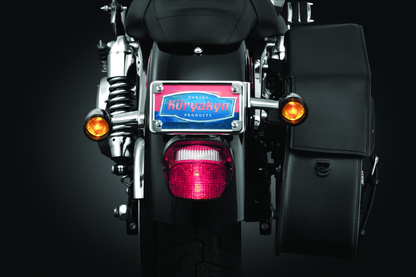 Kuryakyn chrome license plate turn signal and marker light mount for motorcycle, featuring sleek metal design and mounting hardware