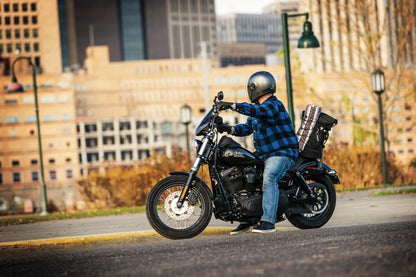 Kuryakyn Momentum Freeloader Duffle bag mounted on a powersports sissy bar, designed for quick attachment and secure storage.