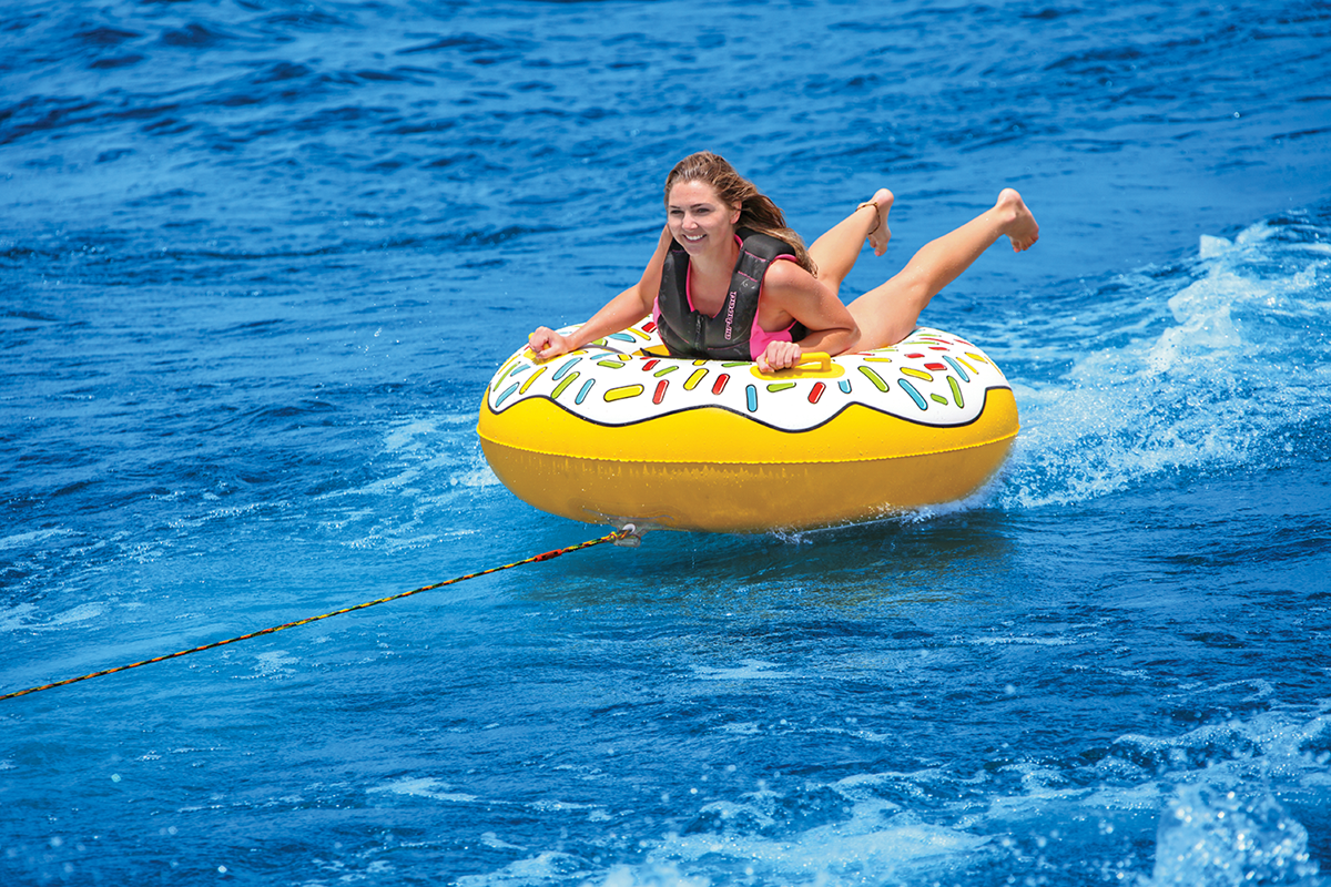 Bill's Exhausts AIRHEAD Sports Group Donut Townut water towable boat float on water with bright colors and inflatable design.
