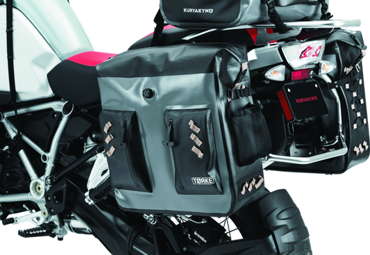 Kuryakyn Torke 24L dry bag panniers for waterproof PowerSports storage, shown mounted on a motorcycle.