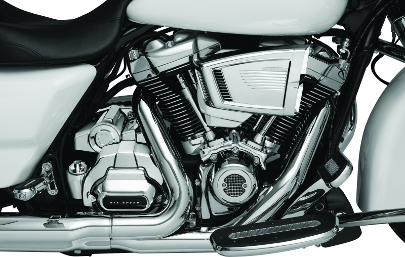 Kuryakyn Milwaukee-8 chrome starter cover for Harley-Davidson models, shiny metallic finish, detailed design, and branding visible.