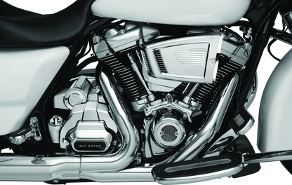 Kuryakyn Milwaukee-8 chrome starter cover for Harley-Davidson models, shiny metallic finish, detailed design, and branding visible.
