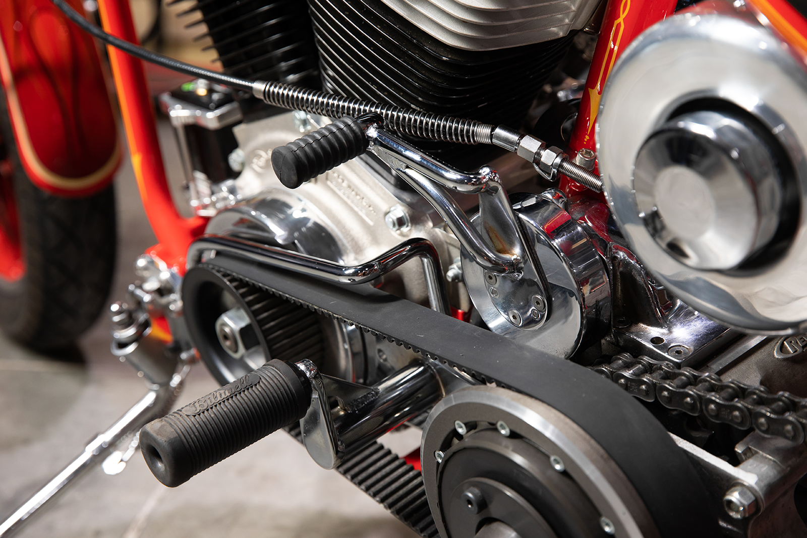 Black BILTWELL Norman foot pegs for motorcycles, shown with metal mounting brackets and textured surfaces for grip.