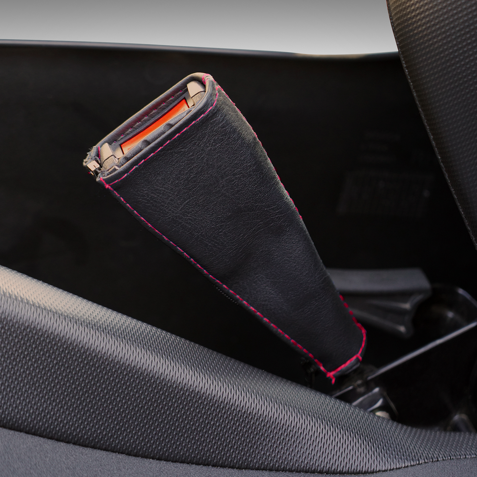 Black SHOW CHROME seat belt covers with red stitching, designed for engine safety and style by Bill's Exhausts.