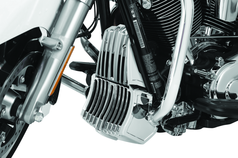 Chrome Kuryakyn oil cooler cover for Harley Davidson Touring models, with detailed chrome finish and branding visible.
