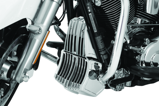 Chrome Kuryakyn oil cooler cover for Harley Davidson Touring models, with detailed chrome finish and branding visible.