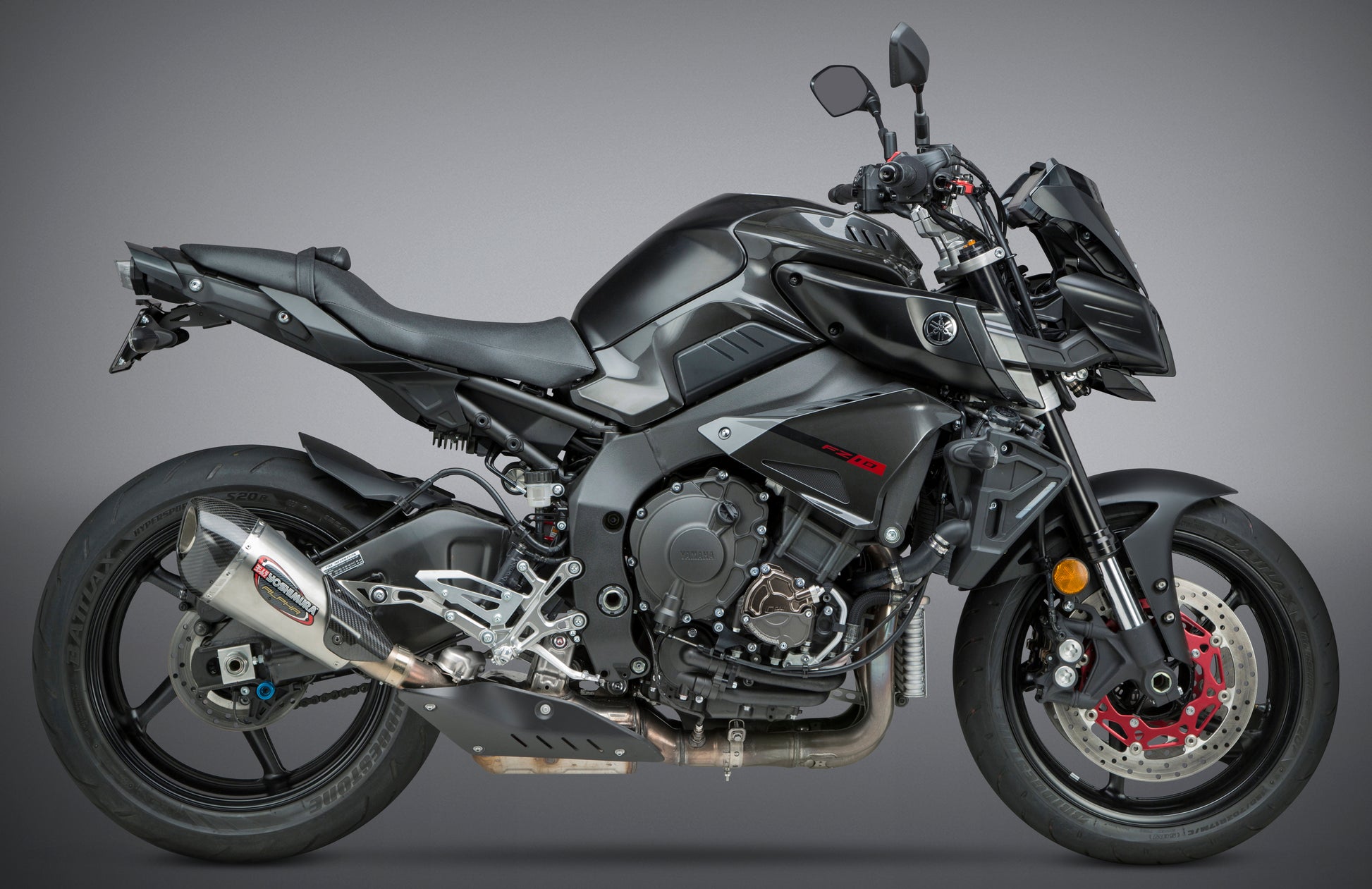 YOSHIMURA Yoshimura Exhaust Street Alpha T Slip-On SS and carbon fiber end cap on motorcycle, showcasing sleek design and stainless steel finish.